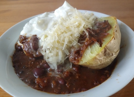 Chilli with jacket potato, cheese, and soured cream